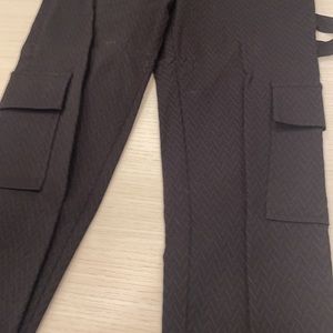 Tracy Reese black cargo fitted pants with leather detail on bottom. Size small.